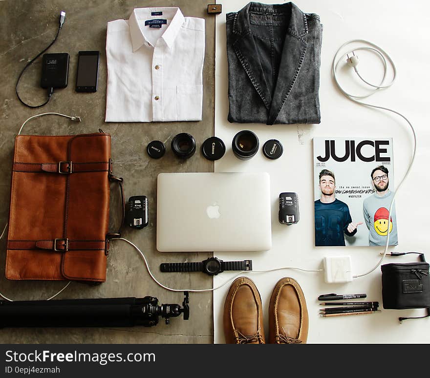 Overhead still life of leather bag with white shirt, jacket, shoes, accessories and magazine. Overhead still life of leather bag with white shirt, jacket, shoes, accessories and magazine.