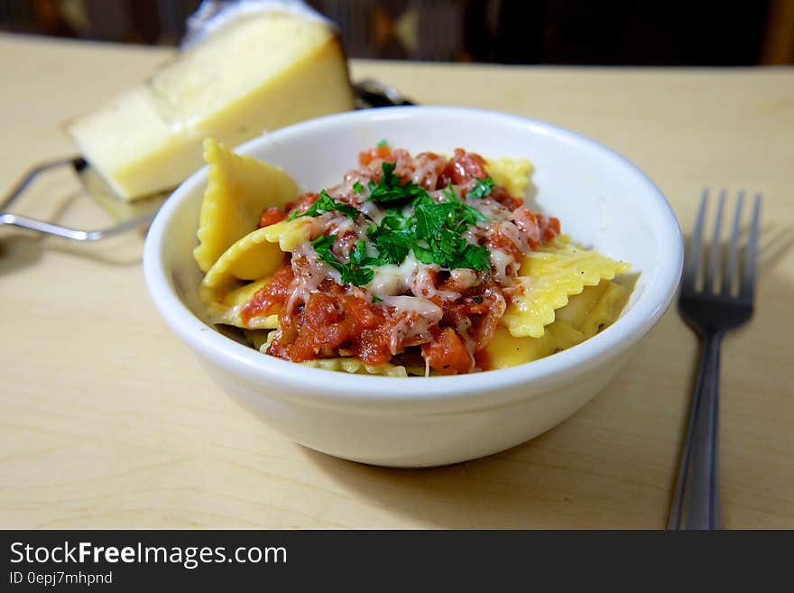 Yellow Baked Pasta on White Ceramic Bowl on Beige Surface