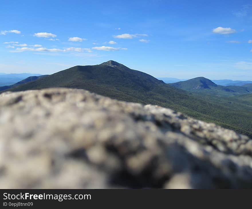 Mountain landscape on sunny day against blue skies.