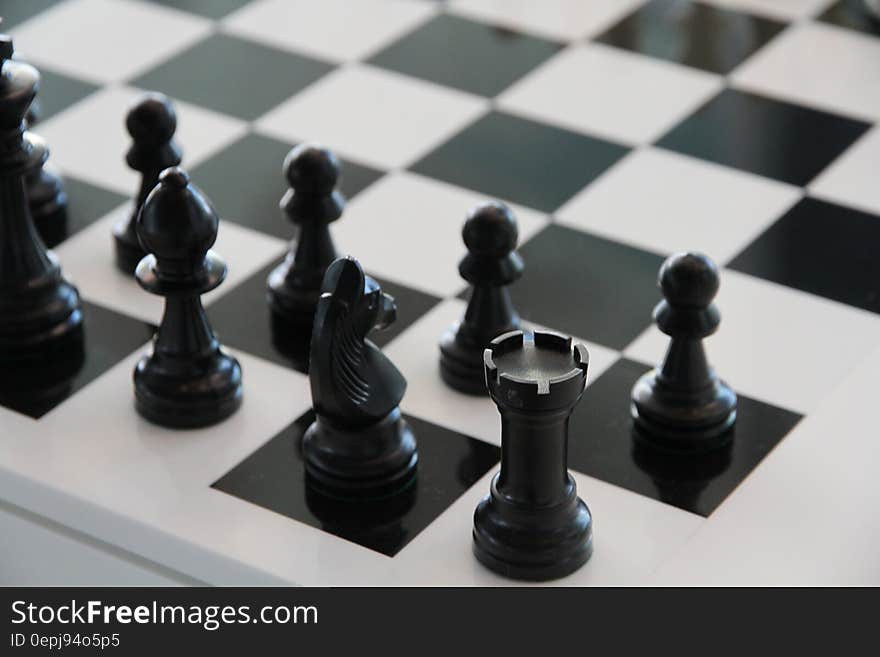 Close up of chess pieces on board in black and white. Close up of chess pieces on board in black and white.