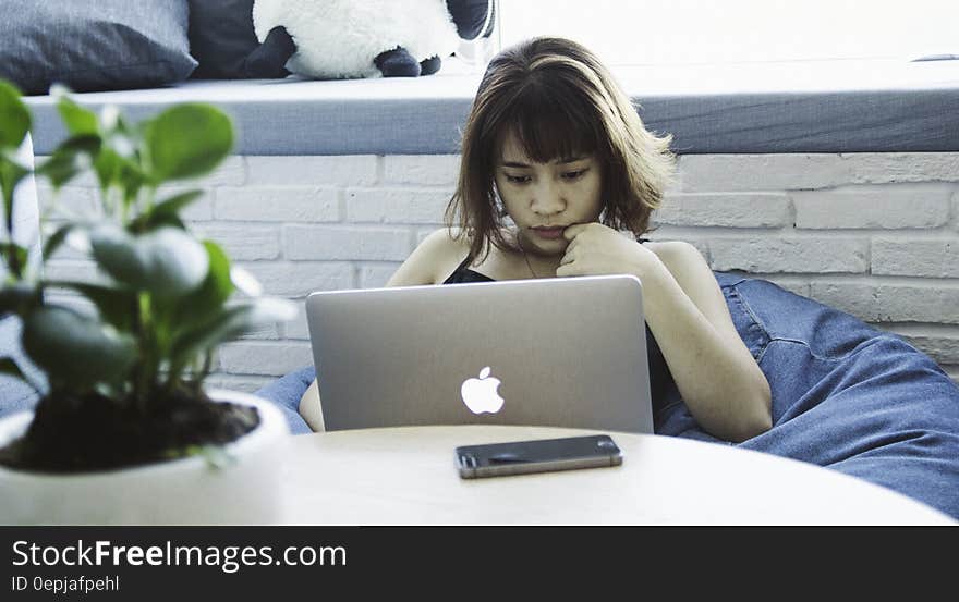 Woman in Black Tank Top Using Silver Macbook