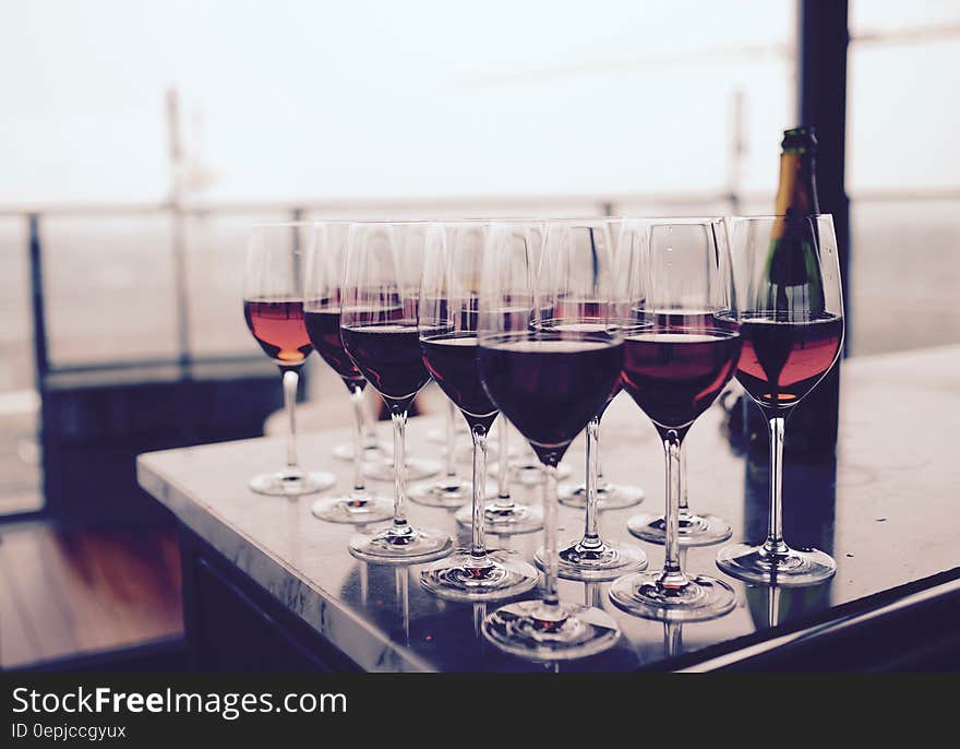 Wine Glass With Red Liquid on Black Table