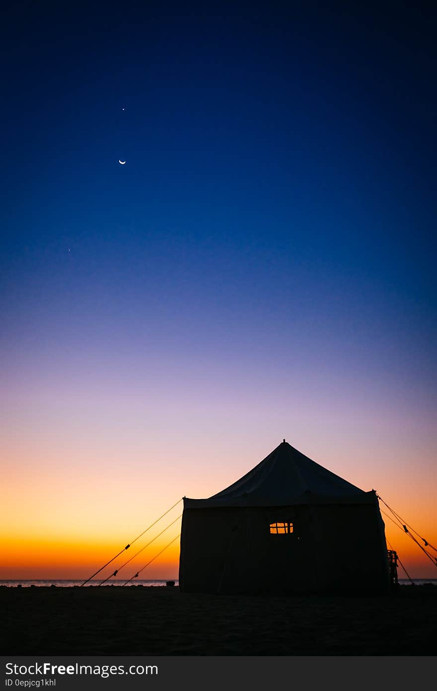 Camping Tent Near Sea Under Blue Sky during Sunset