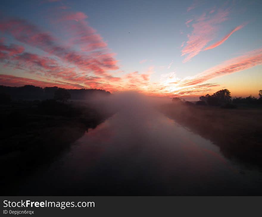 Sun Setting over White Clouds