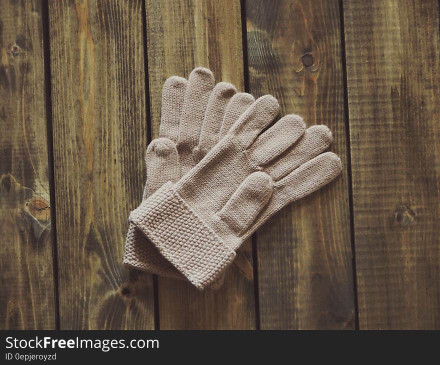 White Gloves on Brown Wooden Surface