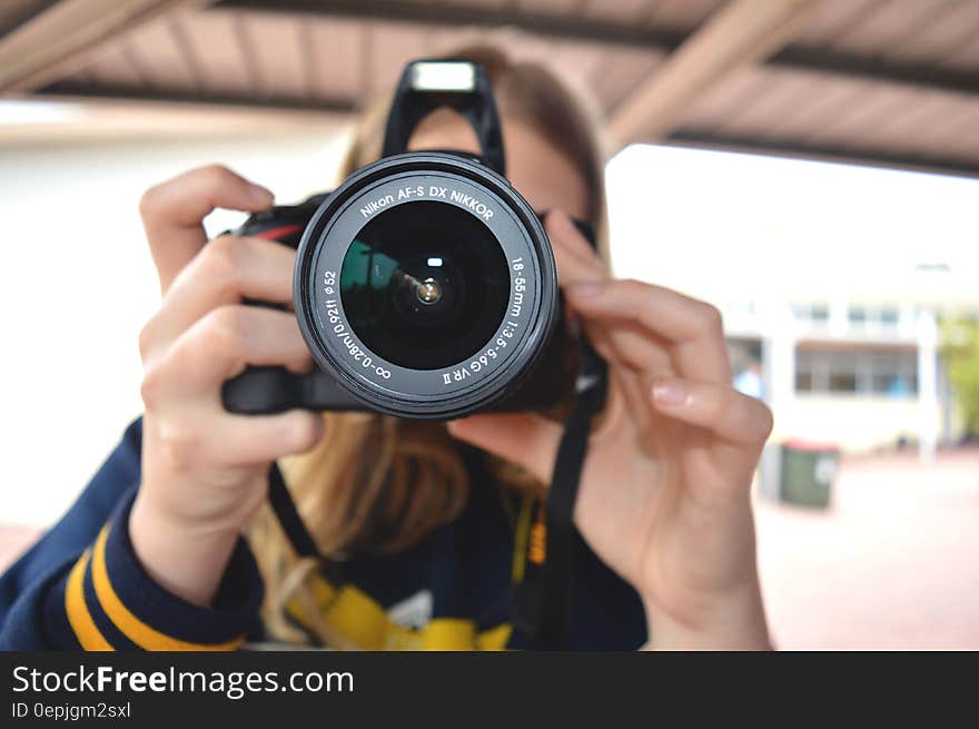 Person Holding Black Dslr Camera