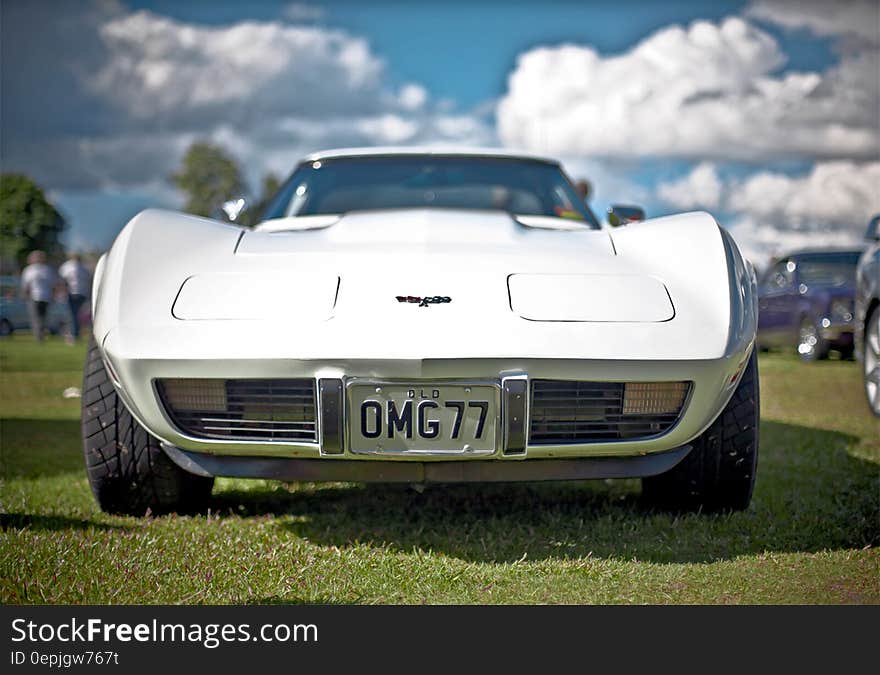 White Corvette C3 With Omg77 License Plate on Display