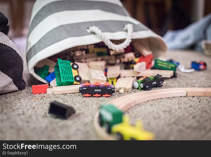 Plastic Toy Car Scattered on Brown Textile