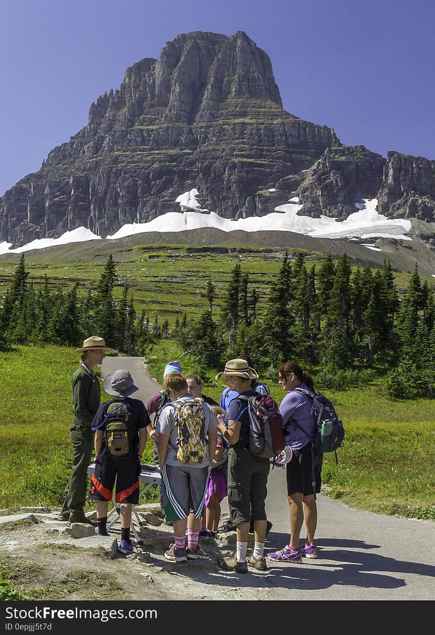 Ranger Claudette is describing flora to a group of visitors in front of Clements Mountain at the beginning of the Hidden Lake Nature Trail. Ranger Claudette is describing flora to a group of visitors in front of Clements Mountain at the beginning of the Hidden Lake Nature Trail.