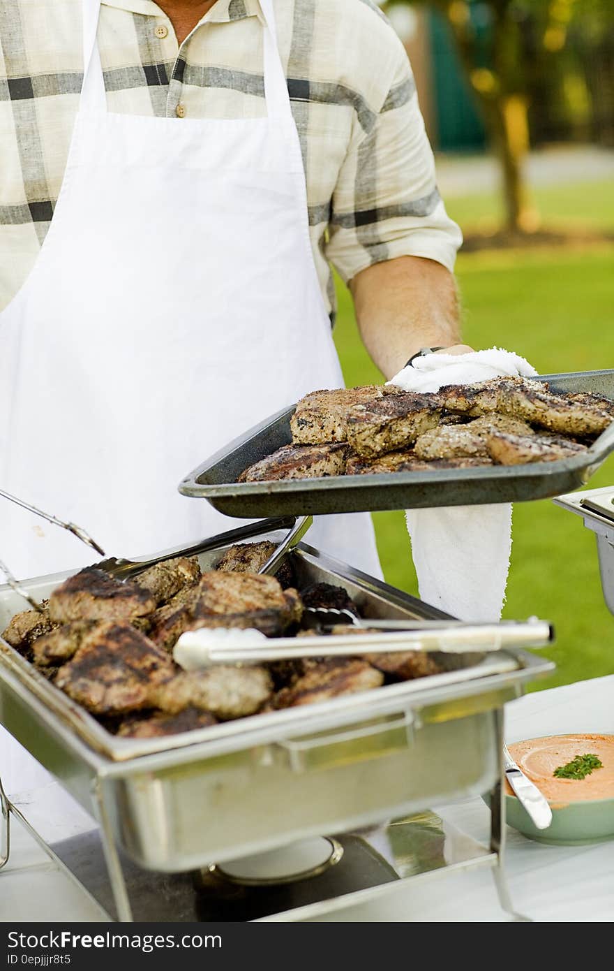 Person Holding Stainless Steel Tray