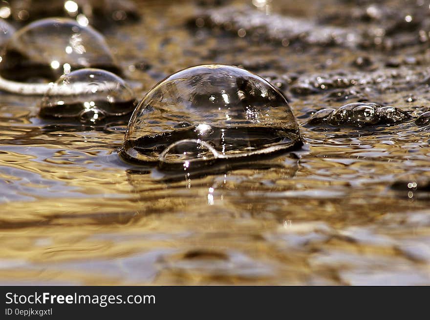 Macro close up of water bubbles on surface.