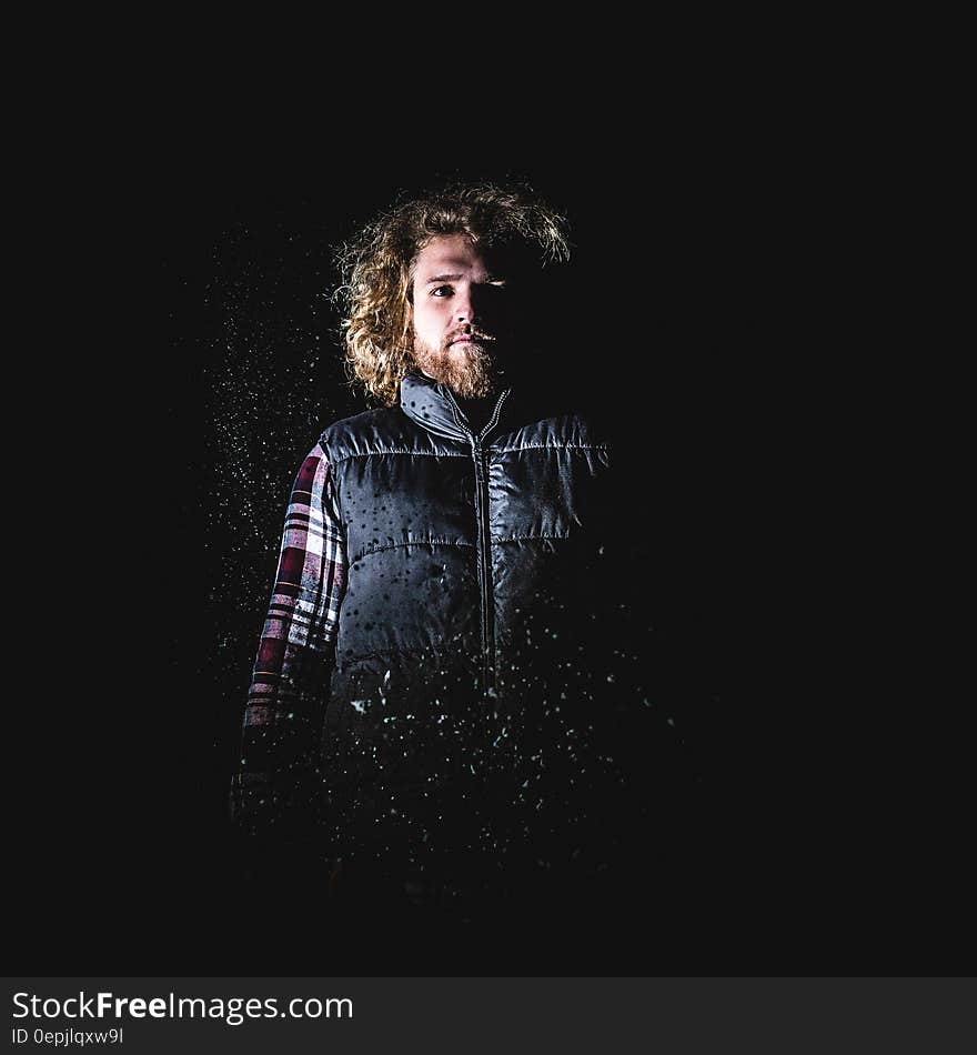 Man in Blond Hair Wearing Black Puffer Vest Standing