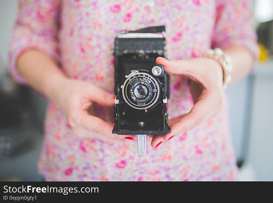 Old analog camera in woman&#x27;s hands