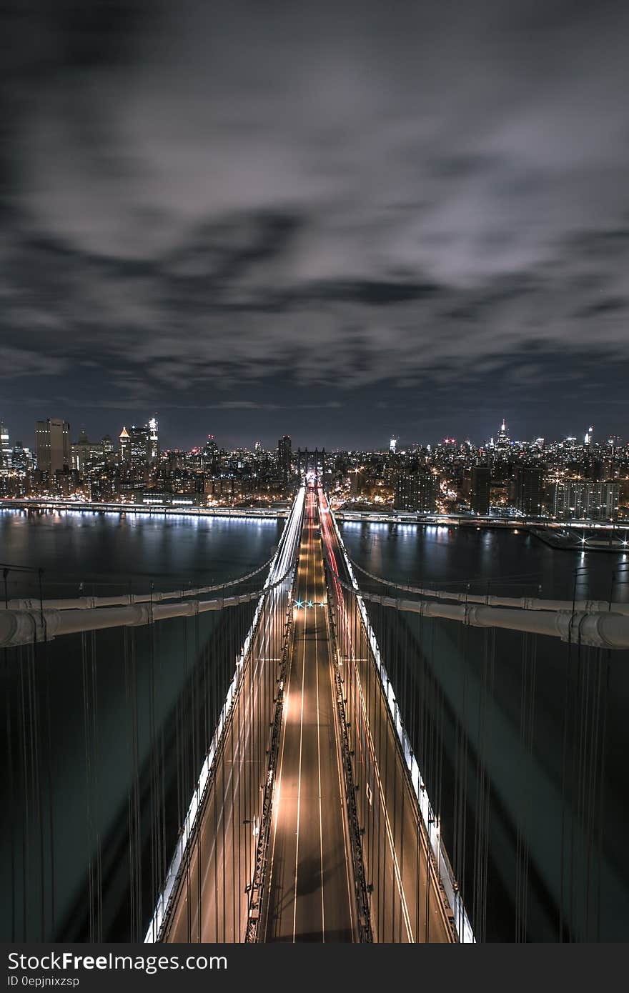 Bridge Under Grey Cloudy Ski during Night Time