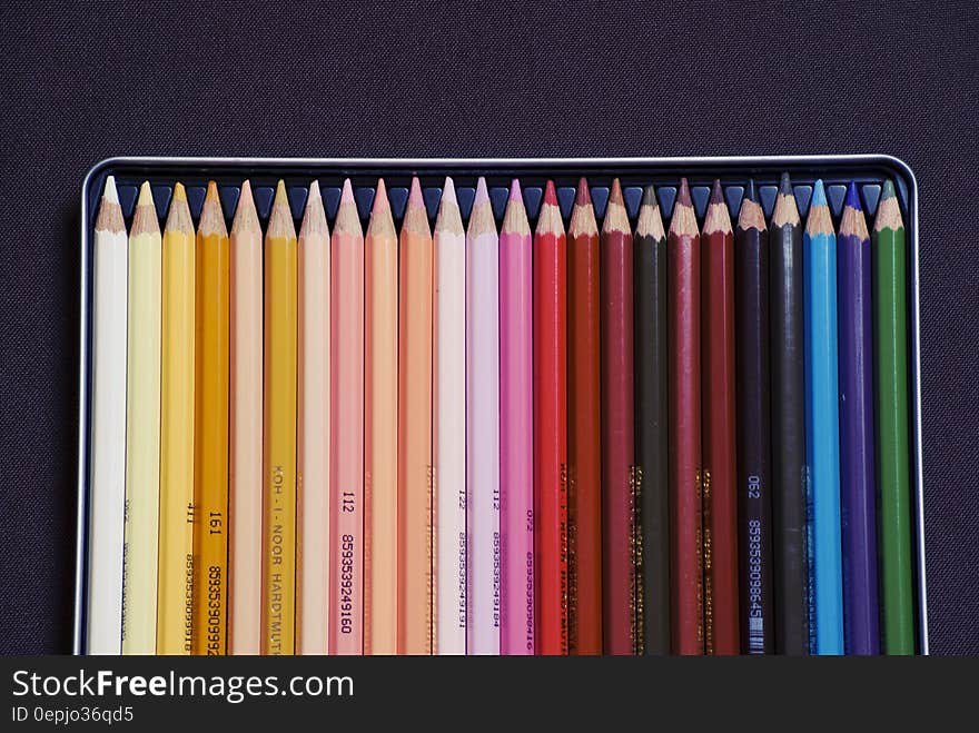 Overhead view of set of coloring pencil crayons in tray with black background. Overhead view of set of coloring pencil crayons in tray with black background.