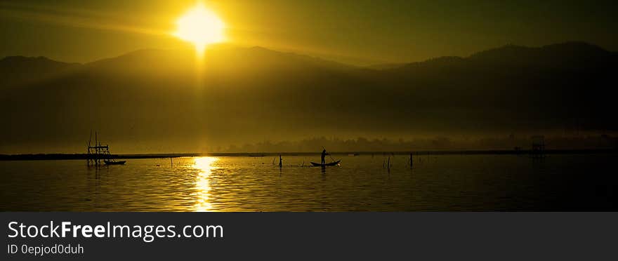 Silhouette of People Riding Boats on Water during Daytime