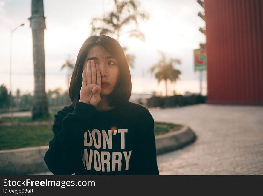 Woman Covering Her Right Eye Using Her Right Hand during Daytime