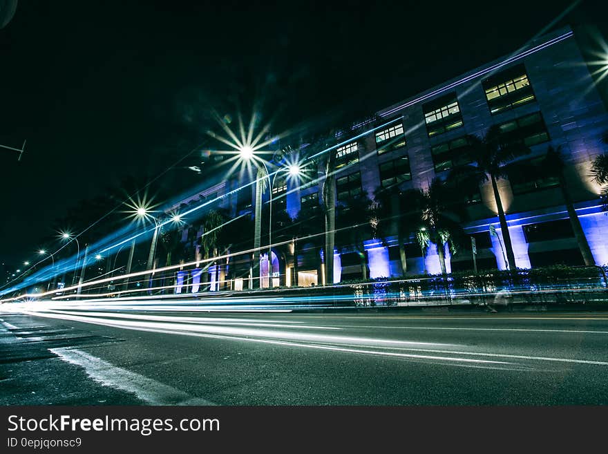 Long exposure view of car lights driving in modern city at night. Long exposure view of car lights driving in modern city at night.