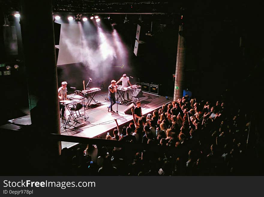 High angle view of band on stage playing concert to audience.