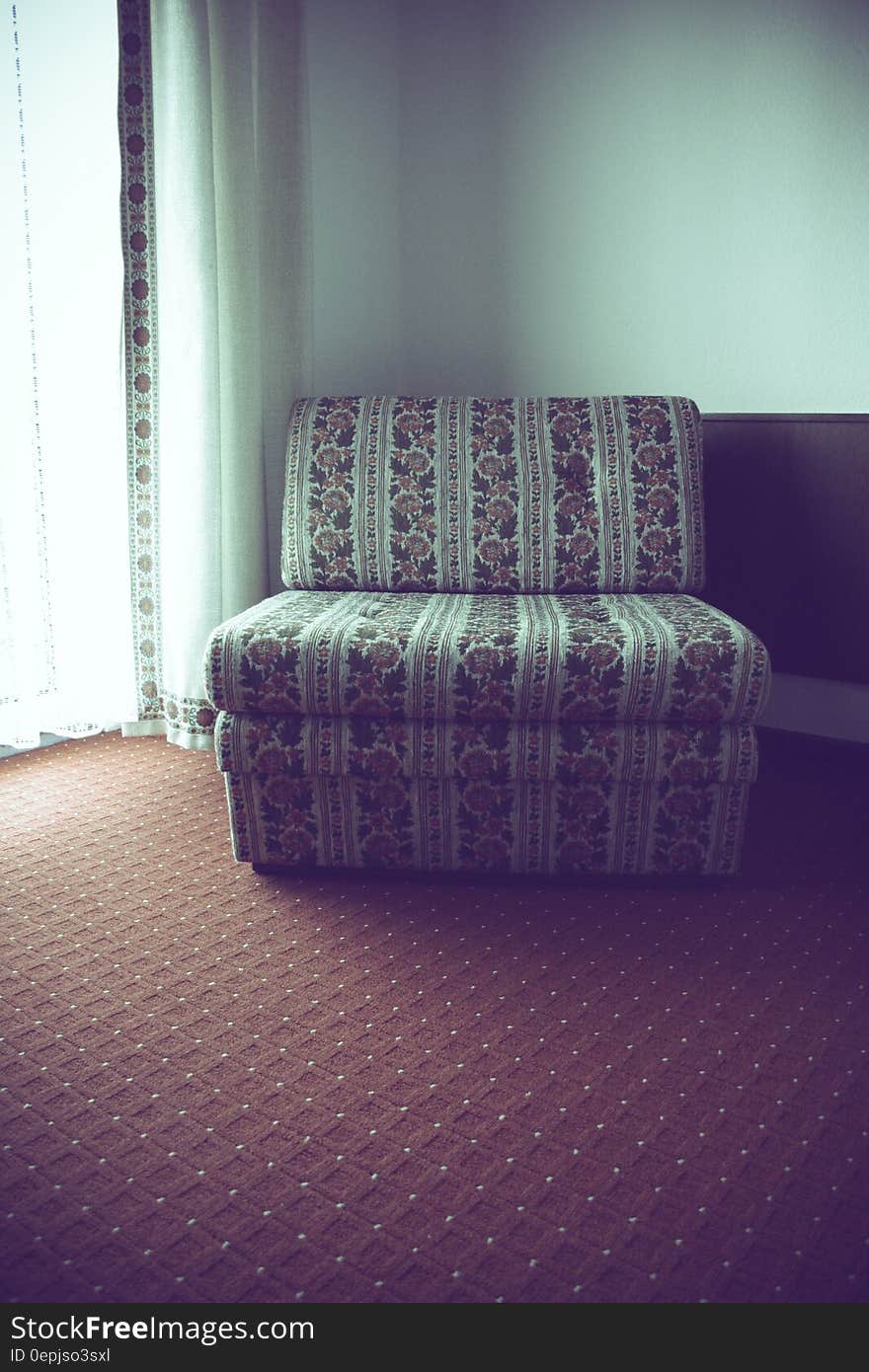 White and Red Floral Fabric Sofa Near Corner Wall