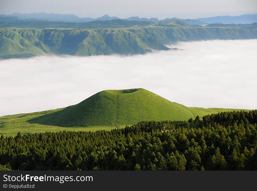 Green Mountain in Front of White Clouds