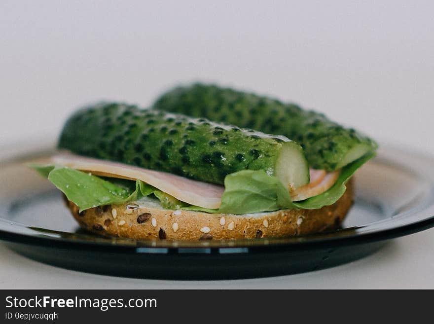 Turkey and gherkin sandwich with lettuce on brown seed bread.