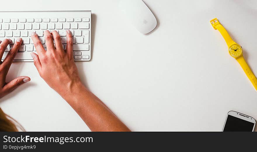 Overhead view of person at desk typing on keyboard with watch and copy space. Overhead view of person at desk typing on keyboard with watch and copy space.