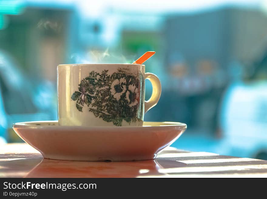 White and Green Ceramic Mug on White Ceramic Plate