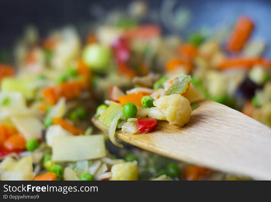 Close up of colorful vegetable pieces on wooden spoon. Close up of colorful vegetable pieces on wooden spoon.