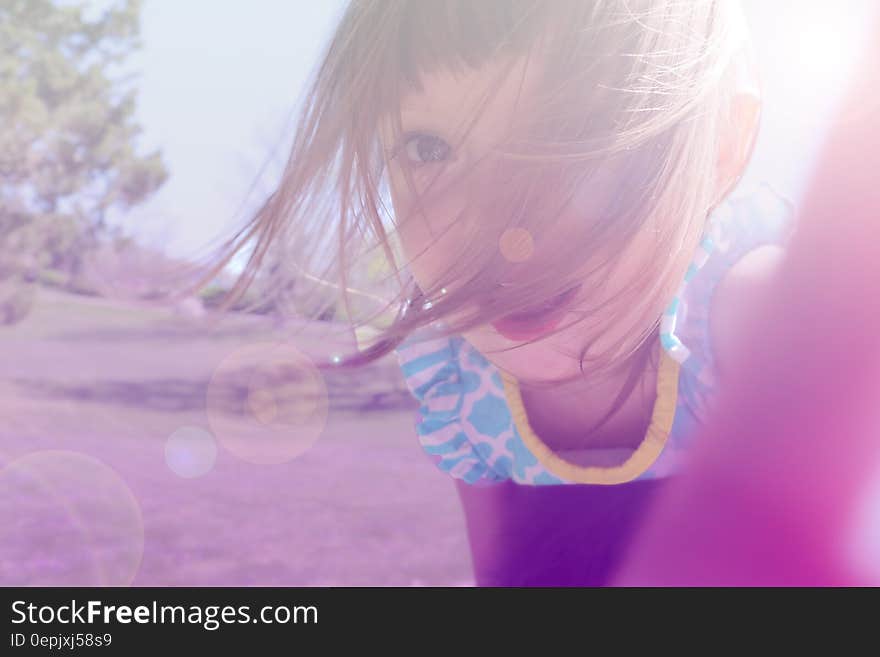 Girl&#x27;s in Yellow and Blue Floral Shirt Taking Photo