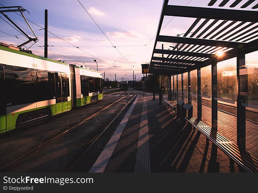 Green and White Train Near Train Terminal during Daytime