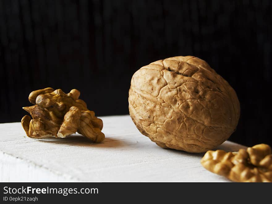 Whole walnut in shell with nut meat pieces on white. Whole walnut in shell with nut meat pieces on white.