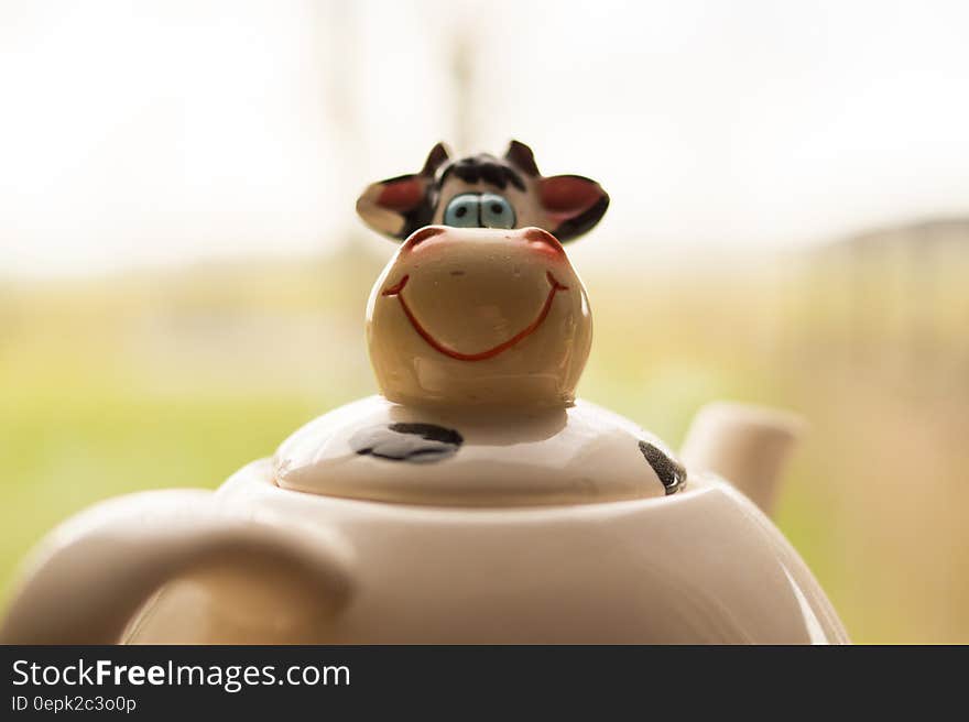 Closeup of funny cows faces on porcelain teapot. Closeup of funny cows faces on porcelain teapot.