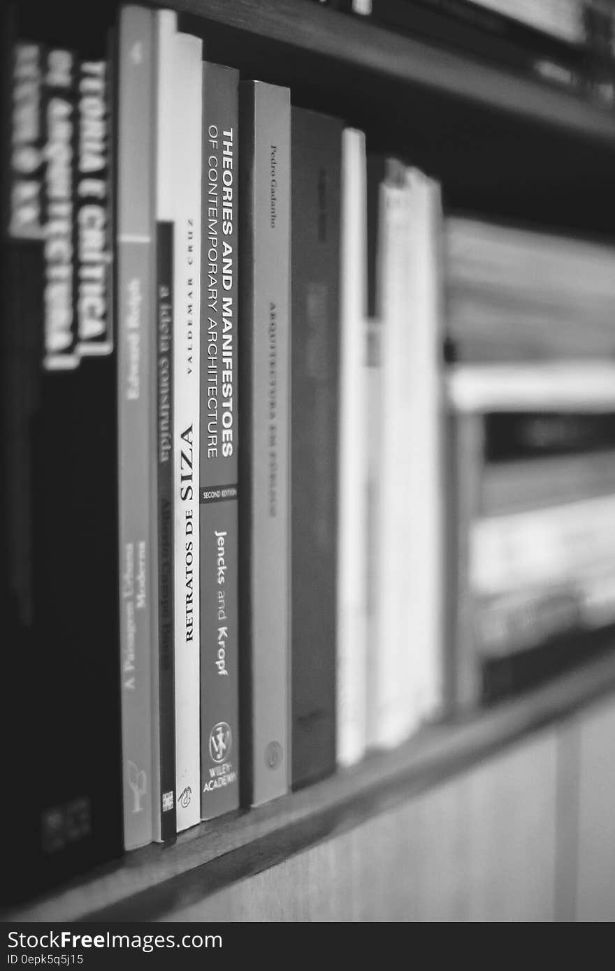 A close up of a bookshelf with various books. A close up of a bookshelf with various books.