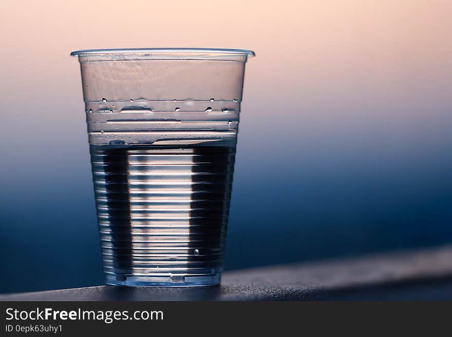 Clear Plastic Cup on Gray Surface