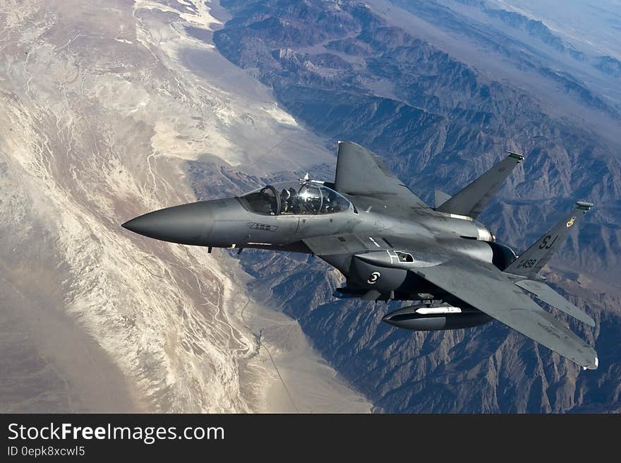 Grey Jet Plane Flying on Top of White Mountain