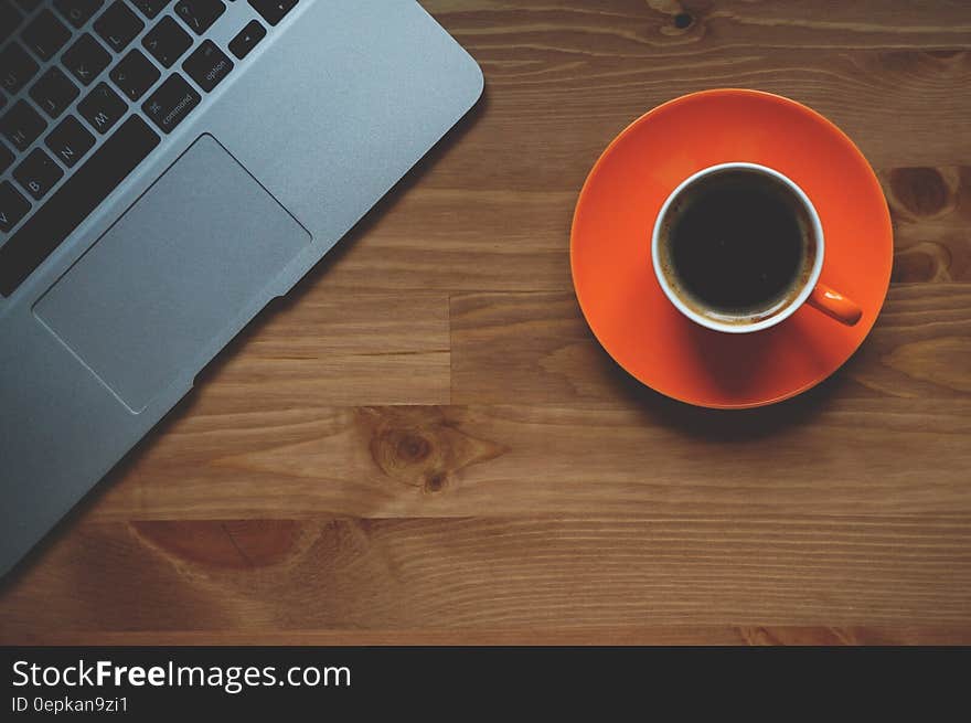 Black Coffee Filled in White Ceramic Mug on Orange Plate