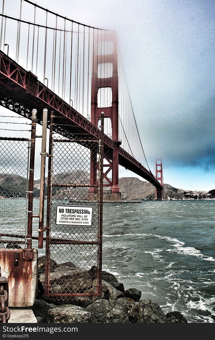 Red Metal Bridge on White Under White Clouds during Daytime