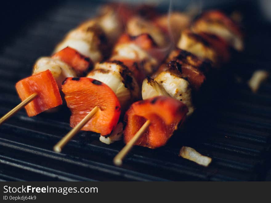 Meat and pepper kebabs on wooden skewers on barbecue grill pan. Meat and pepper kebabs on wooden skewers on barbecue grill pan.