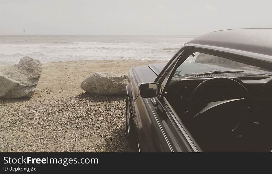 Black Car Parked on the Seashore