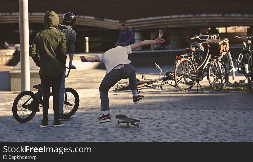 Man in White Shirt Doing Skateboard Trick