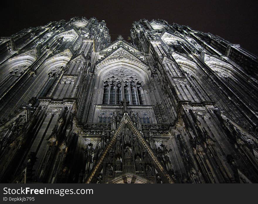 Low Angle Photography of Gray Concrete Cathedral at Nighttime