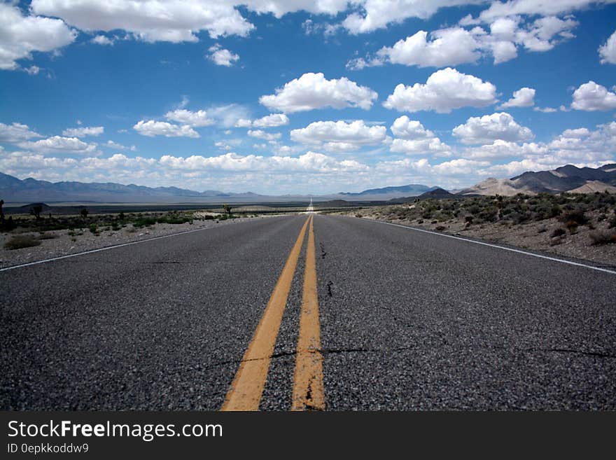 Black Top Road Under Clear Blue Cloudy Sky