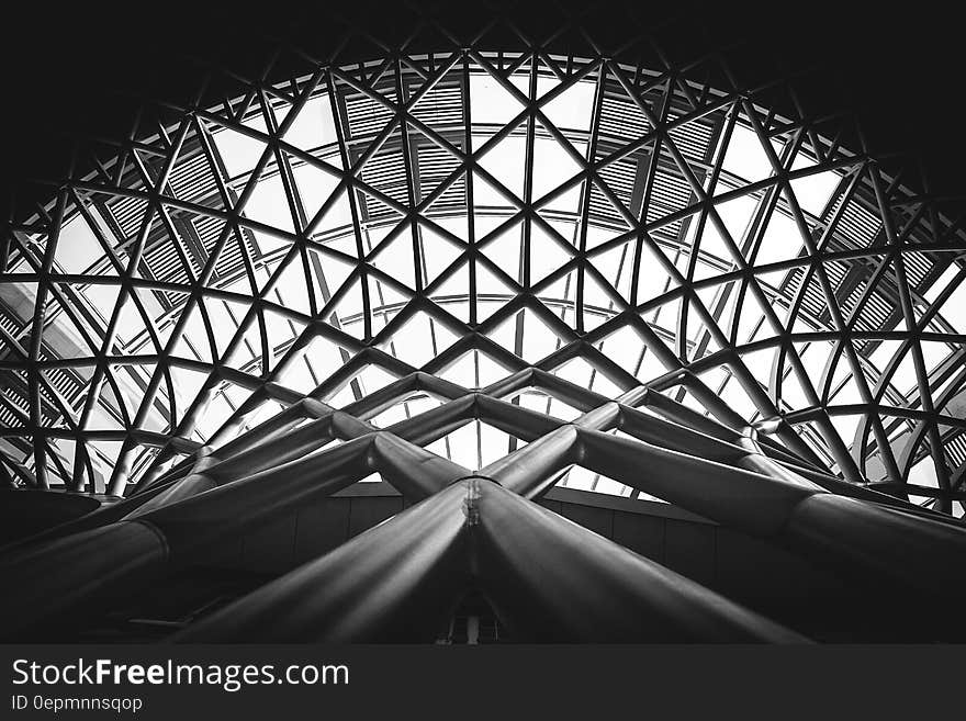 Low Angle Photography of Metal Building on Grayscale