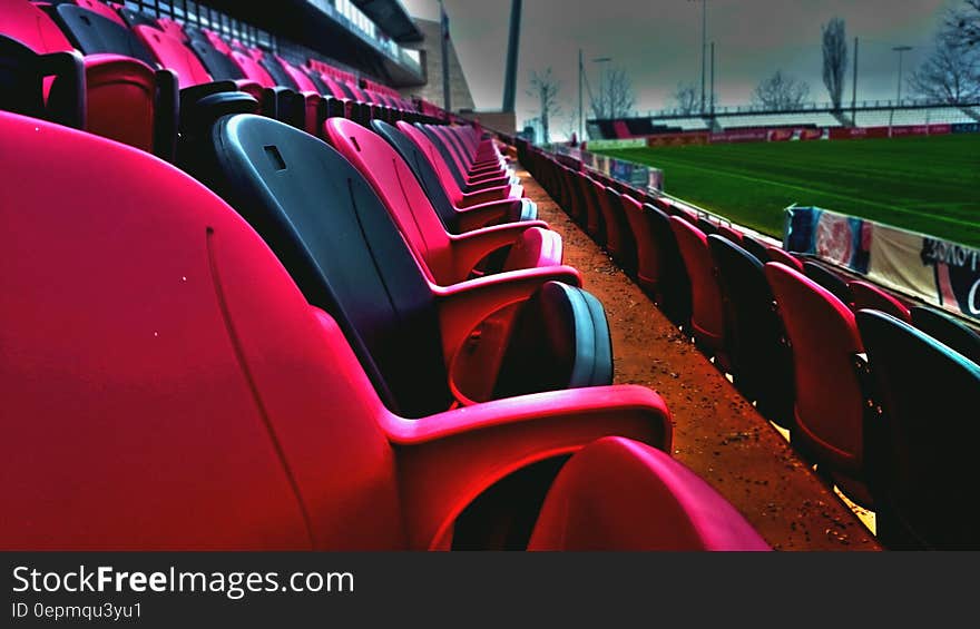 Empty seats in baseball stadium along green field. Empty seats in baseball stadium along green field.