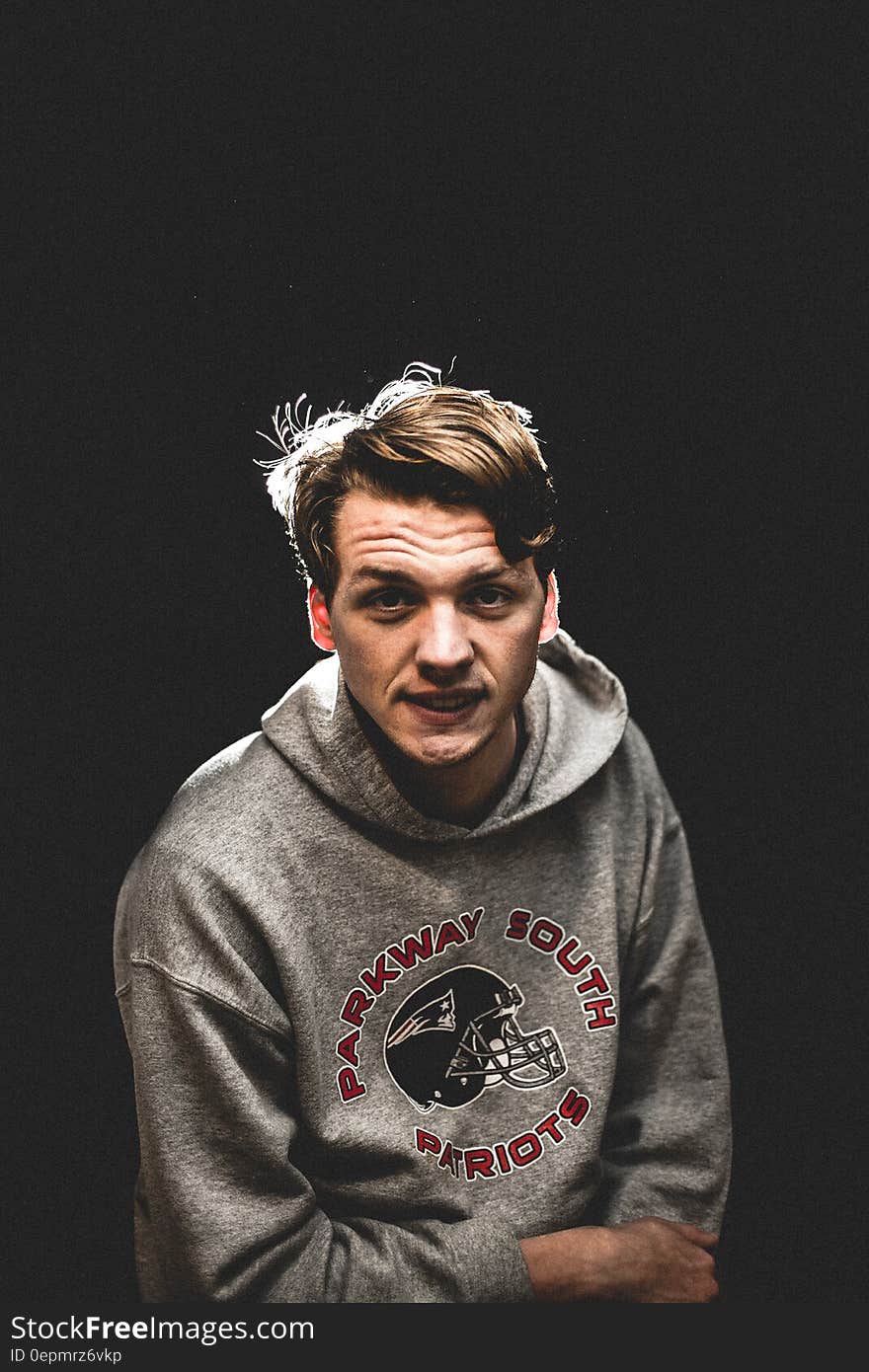 Studio portrait of man wearing Parkway South Patriots football sweatshirt. Studio portrait of man wearing Parkway South Patriots football sweatshirt.