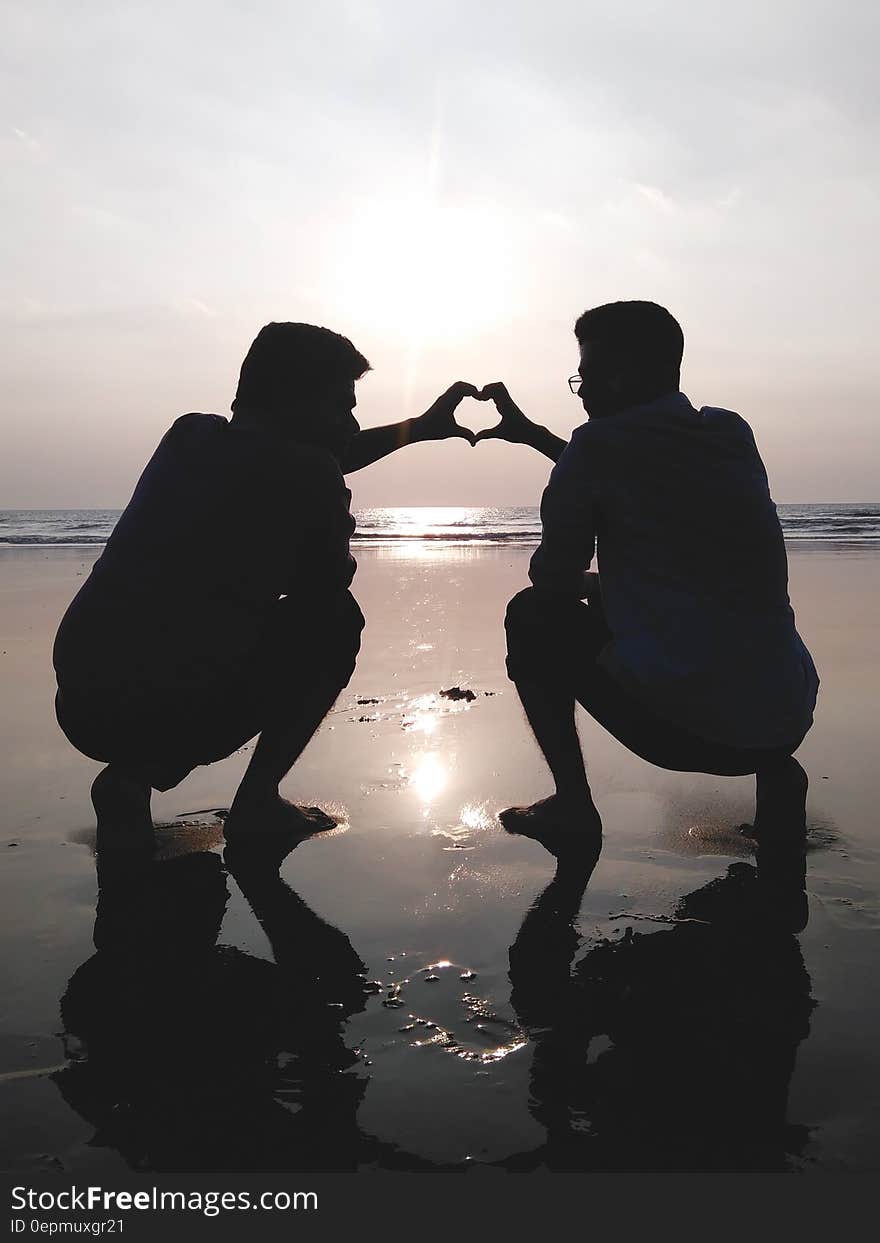 Silhouette of 2 Man Making Heart Sign