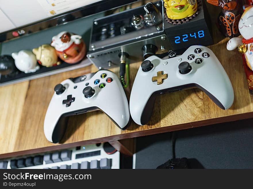 Game controllers on wooden shelf. Game controllers on wooden shelf.