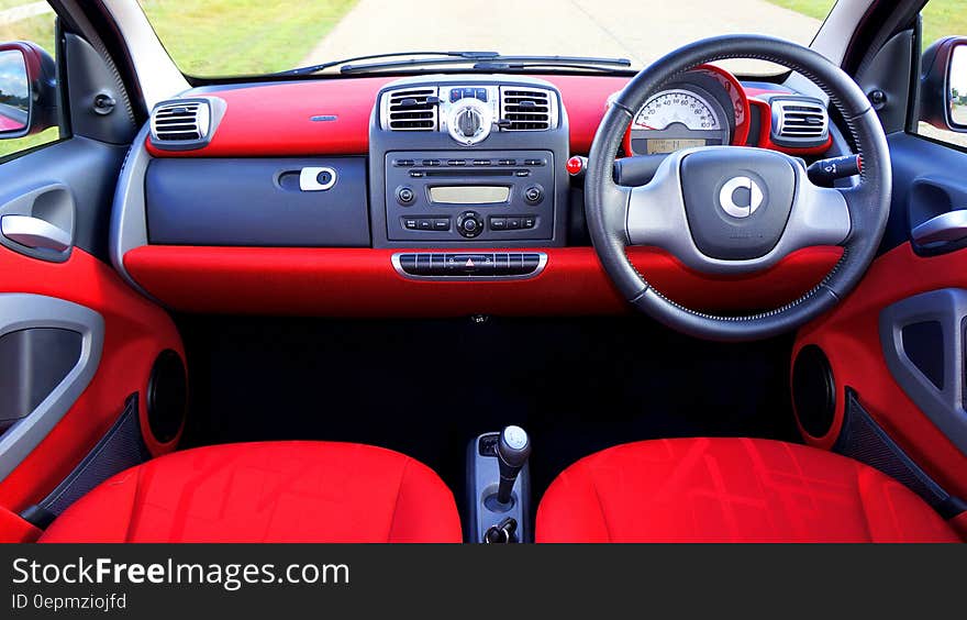 Interior of car with red seats and leather steering wheel. Interior of car with red seats and leather steering wheel.