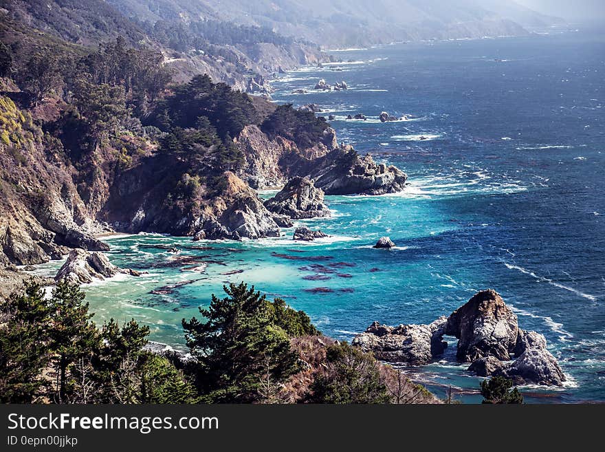 Rocky bay along coastline on sunny day.